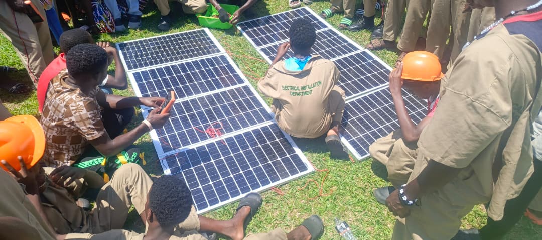 Vulnerable youth learning solar panel installation