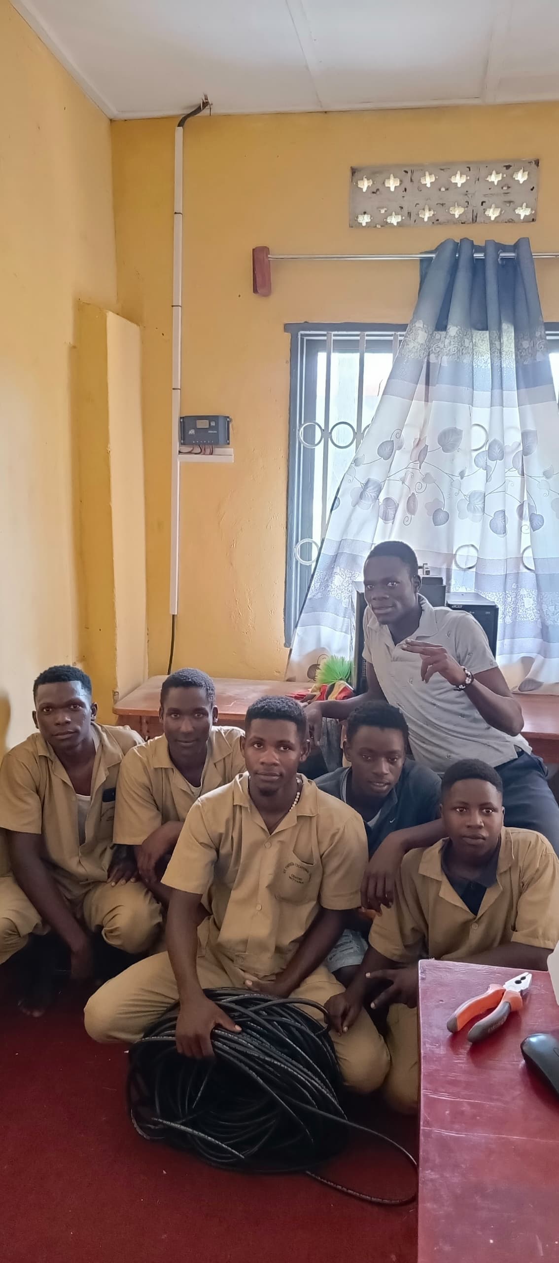 Trainees working on solar charge controllers